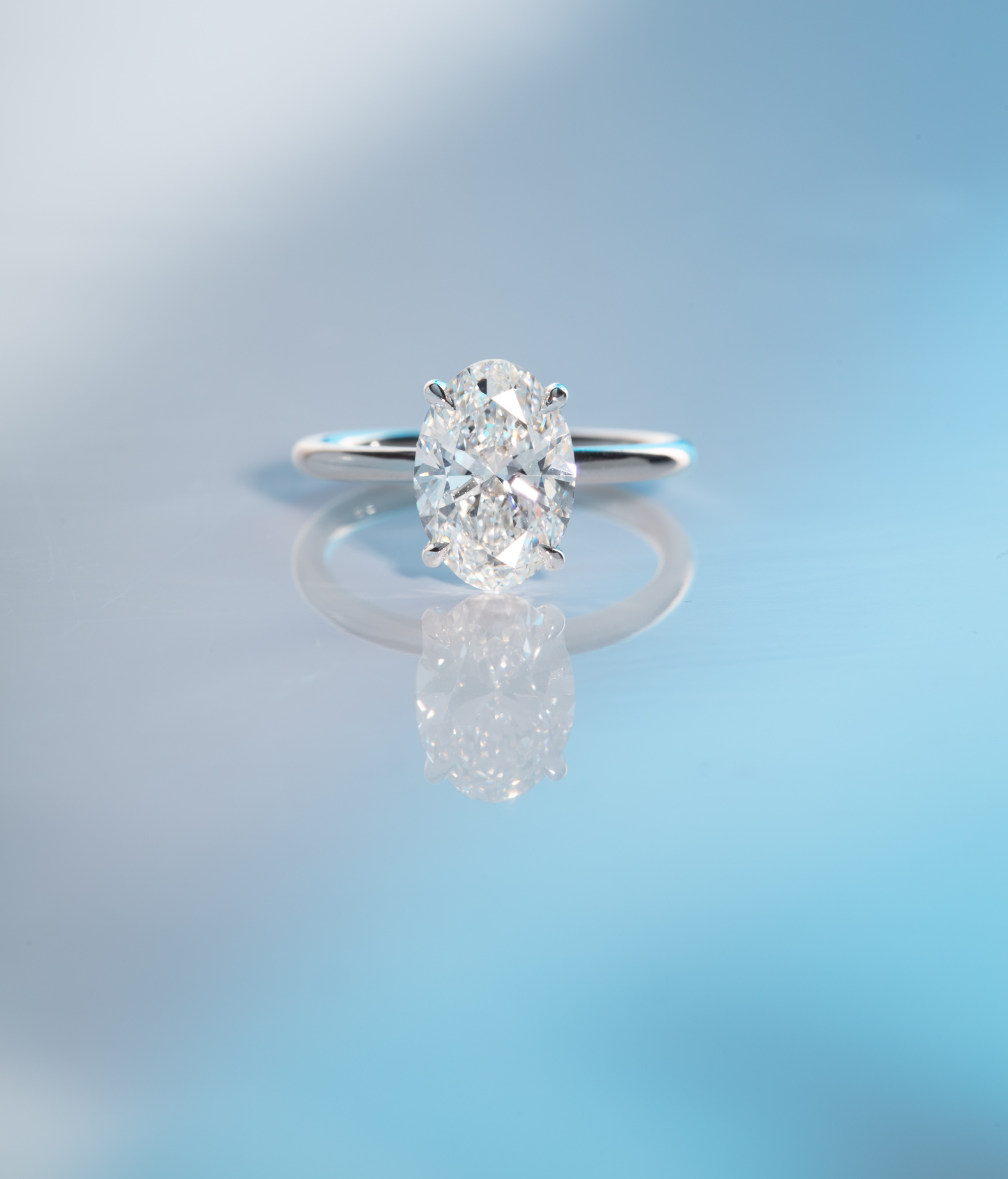 Or & Elle Engagement Suite. A custom 2.5 oval diamond engagement ring with a thin 18K White Gold and Palladium band. Or & Elle specializes in creating any custom engagement ring - using superlative diamonds and 18K recycled gold.