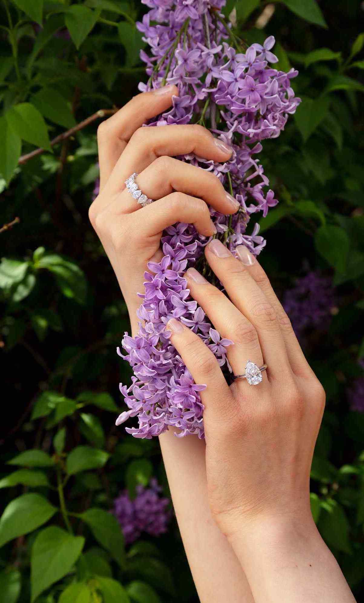 Diamond shapes - Pears, also known as teardrop diamonds, are among the most unique cuts. They have the brilliance of a round and the elongating effect of a marquise. A model wears a custom 3.5 carat pear engagement ring, made with 18K White Gold and Palladium, with a Sans Cesse Pear Eternity band (5 total carat weight, also made with 18K White Gold and Palladium)