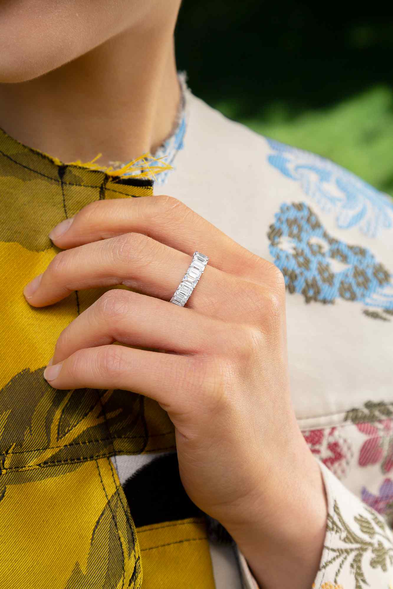 Diamond Shapes - Emerald is a regal, step-cut diamond, that gives the appearance of a hall of mirrors. Clarity is paramount for this shape. A model wears the Sans Cesse Emerald Eternity Ring - 18K White Gold and Palladium with lab-grown, D color diamonds. Ring shown here is 7 total carat weight.