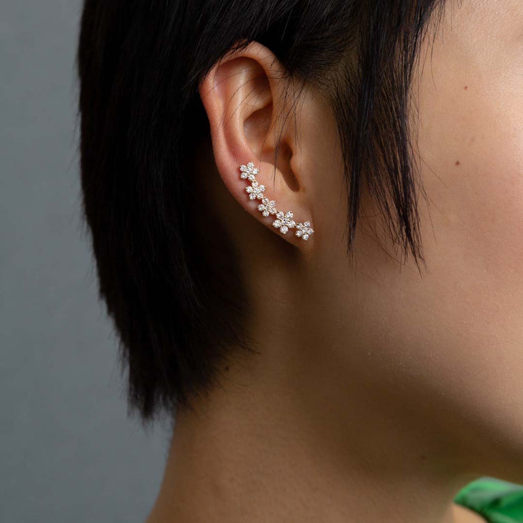 The earrings construct a floral garland of 2.2 total carat weight of diamonds that comfortably wind up the ear.