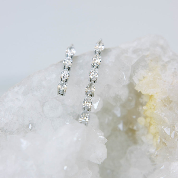 Hand-cast from 2.5 grams of recycled 18k gold, these pear diamond earrings feature four pristine tear drops floating in an architectural column. The pair of earrings is 1.4 total carat weight. The shape and size is fully customizable. Earrings sold as a pair.