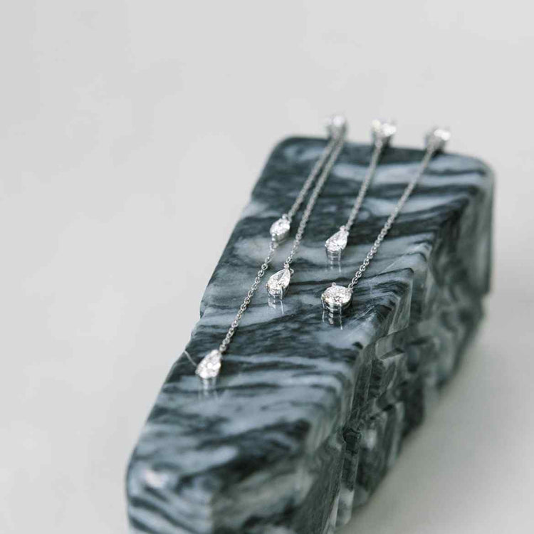 The Lariat Trois earrings shown here with a custom jacket (or additional chain with a diamond) that attached through the stud. Also shown with the Lariat Deux. All D color, IF/VVS clarity diamonds.