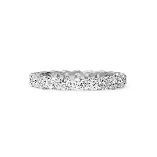 Or & Elle's Sans Cesse Round diamond eternity band features D color, IF/VVS clarity round brilliants held in recycled 18k gold by an elegant scalloped setting. Size and color are fully customizable. White gold shown here. Available in two carat weights: 2.5 and 5 (based on a U.S. size 7).