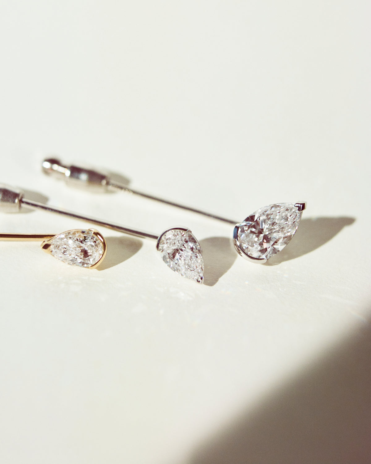 Feuilles Flottantes - 3 Single Diamond Lapel Pins with D color, IF/VVS Clarity, and Ideal cut Diamonds. Cut is the most important determinant of sparkle and the only element determined by craftsmanship rather than by chance. To achieve the play of light that makes superior diamonds shine maximally, Or & Elle’s craftsmen cut and polish each facet with breathtaking precision.
