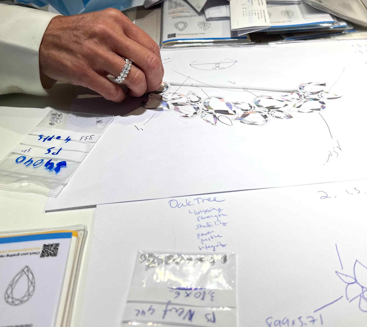 Custom Process: Design Consultation - To design a bespoke Or & Elle piece, please fill out the intake form on this page or contact our Atelier. We’ll then schedule a virtual meeting to learn all about your vision and timeline.  No vision is too small or too large. Our custom creations range from timeless jewelry box staples to once-in-a-lifetime celebrations. Shown here, an artisan is assessing her computer model of the Brance d'Arbre lapel pin, which was custom made for Pete Davidson for the 2022 Met Gala.