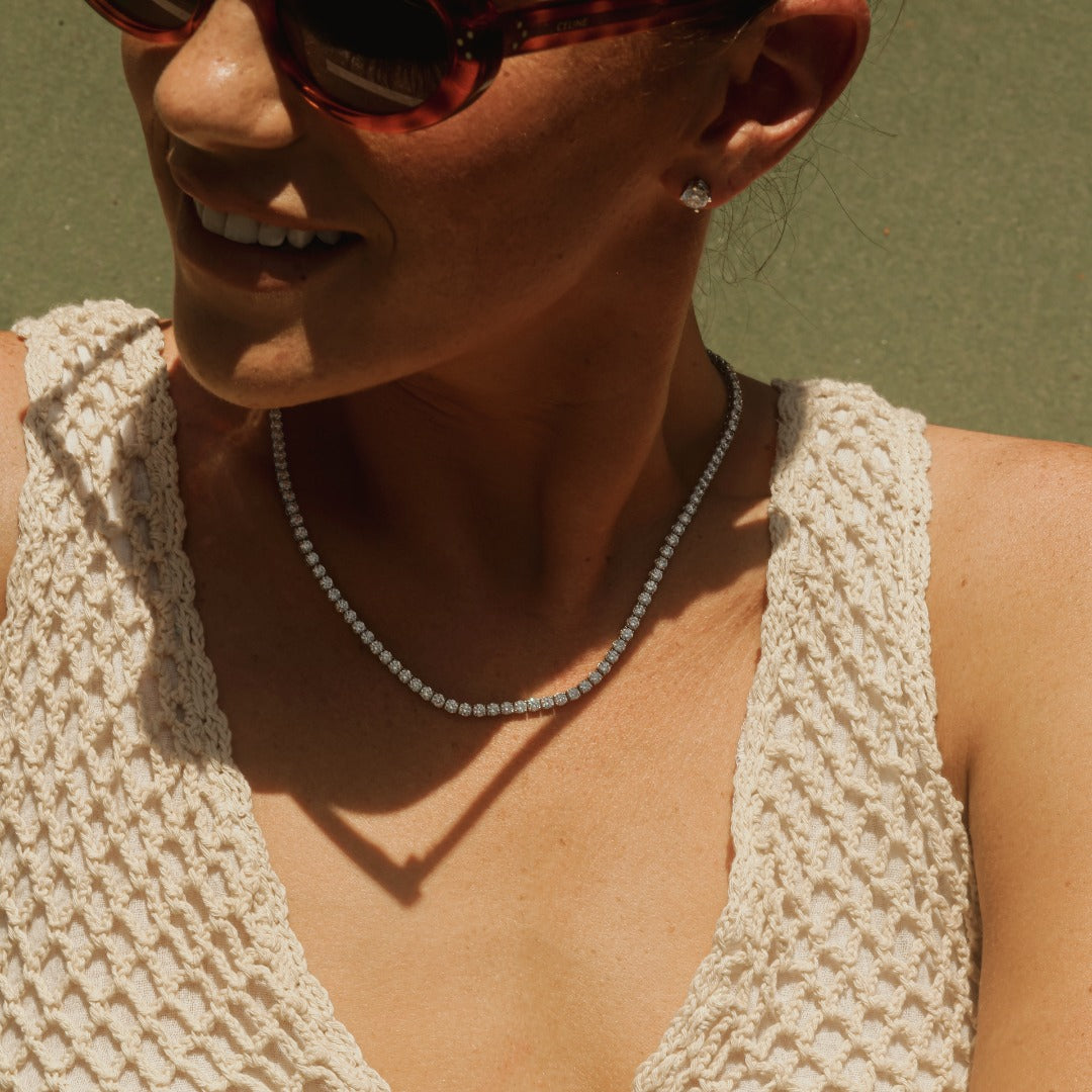 The Collier de Diamants Tennis Necklace paired with the Île Studs, elevating this chic crochet summer dress. All pieces feature D color, IF/VVS clarity diamonds.