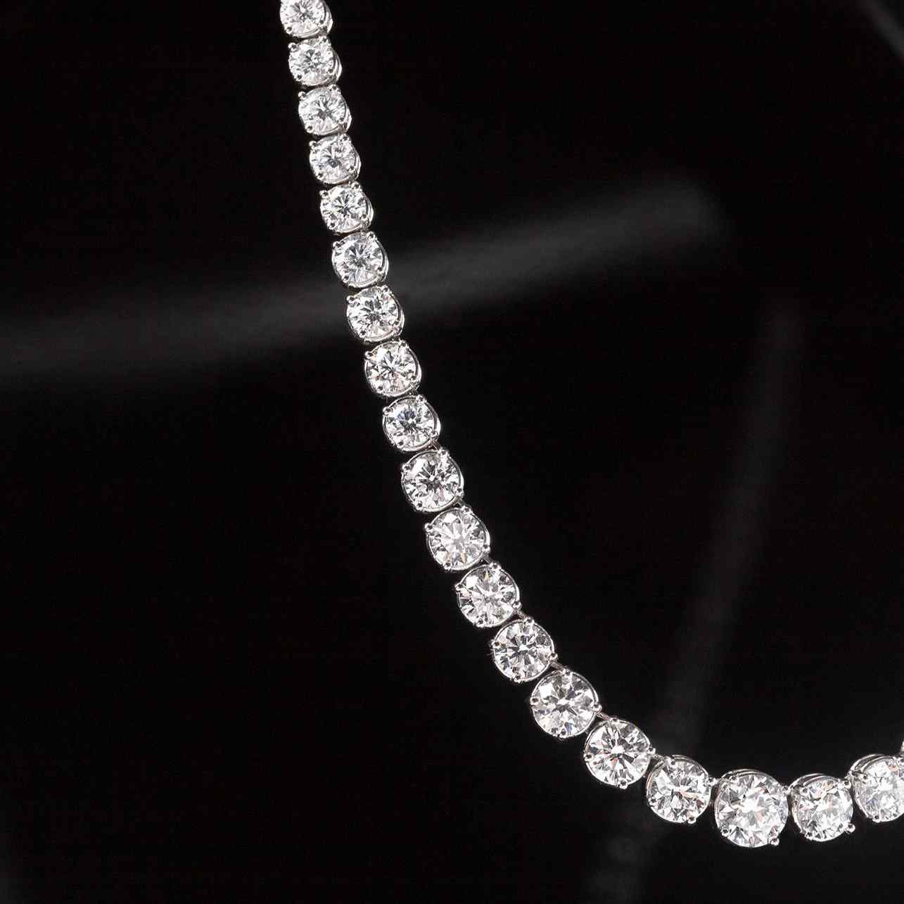 The Collier Rivière Necklace features graduated diamonds - a crescendo towards the main (and largest) diamond that sits at the center of this necklace. 