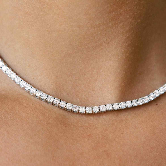Model wears our diamond tennis necklace - which features round brilliants in a four prong solitaire setting. Diamonds wrap the entire length of this 16-inch (40cm) necklace in 18K White Gold.  15tcw necklace is shown in photos.