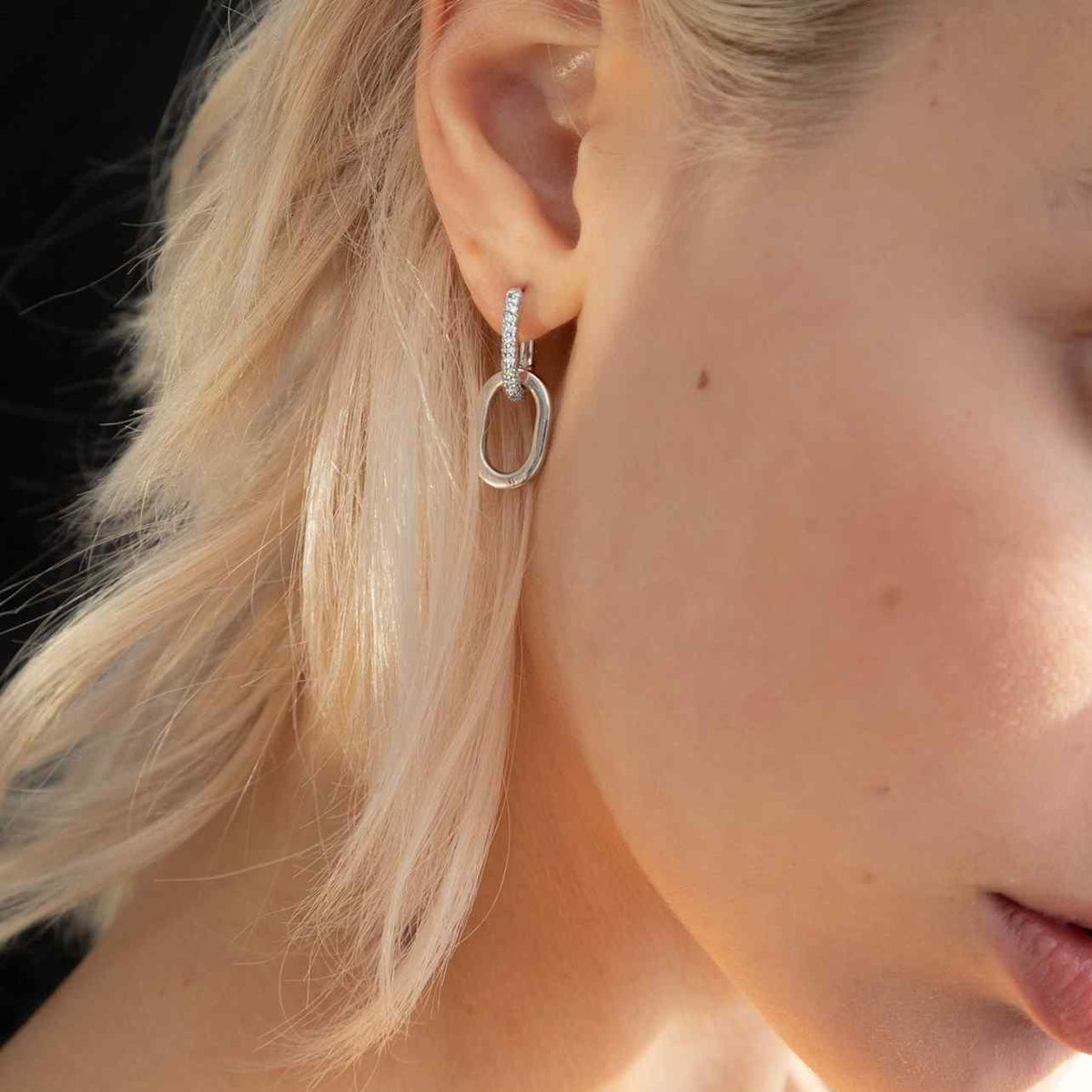 Floating Ecluse double link earrings have complementary diamond / gold links. The left earring has diamonds on the first hoop and gold on the second link - whereas the other earring has the opposite (gold on the top hoop and a diamond hoop attached below). White Gold shown here.