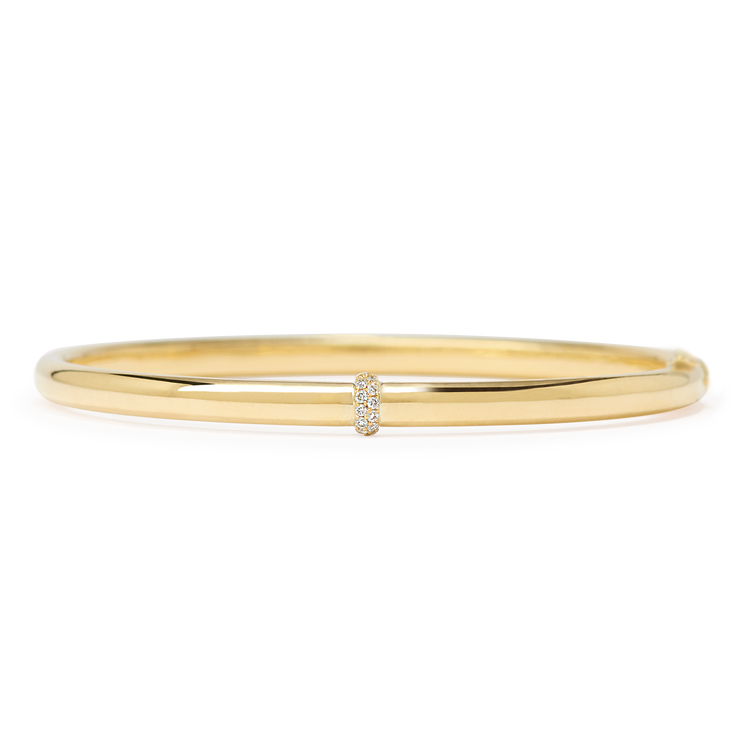 A delicate band of diamonds encircles one point along a 24-gram gold bangle. Our Dalliance Gold bracelet has an inner circumference of 6.3" (16 cm) with a long axis of 2.2" (5.6 cm) and a short axis of 1.8" (4.6 cm). 18k recycled yellow gold shown here. Please reach out to our Atelier to customize the size of the bracelet.