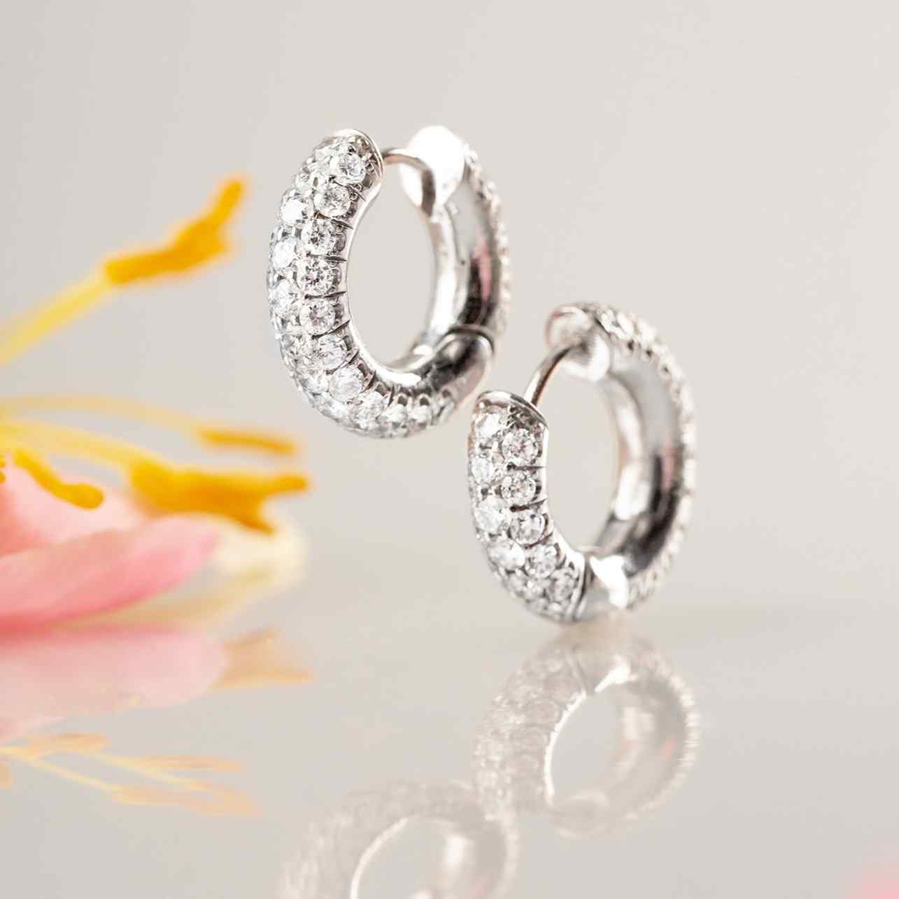 The Dalliance Pavé Hoops feature 100 brilliant diamonds that cover the front and back of these wide pavé hoops. Featuring 8 grams of 18k gold and nearly 2ct of diamonds. Earrings sold as a pair.