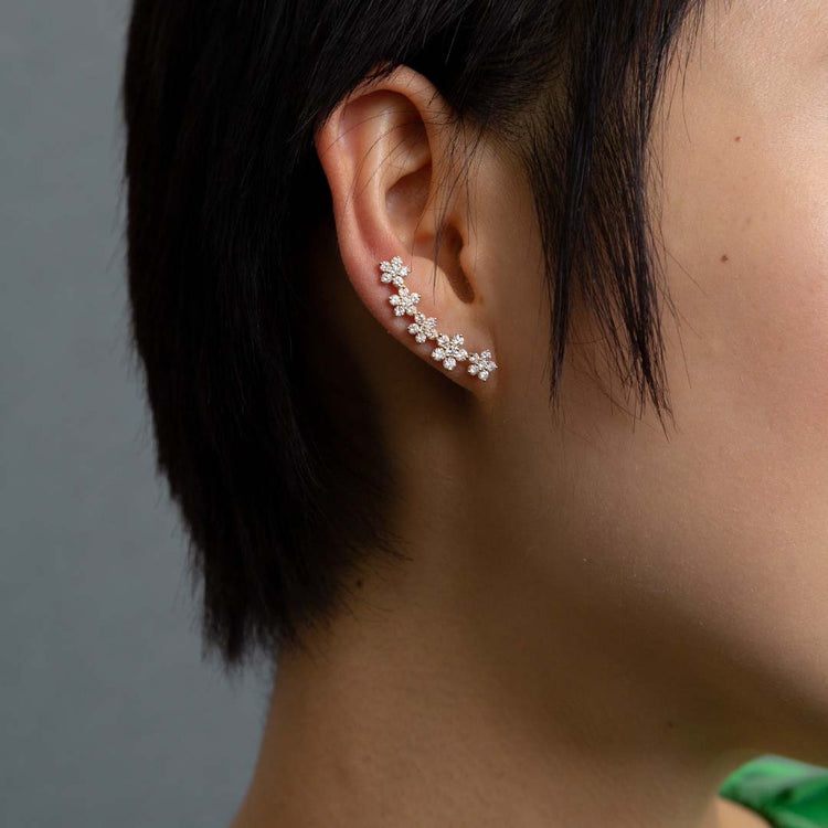 The earrings construct a floral garland of 2.2 total carat weight of diamonds that comfortably wind up the ear. 