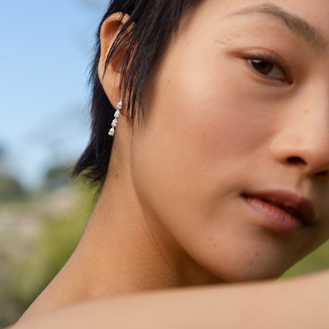 Hand-cast from 2.5 grams of recycled 18k gold, these pear diamond earrings feature four pristine tear drops floating in an architectural column. The pair of earrings is 1.4 total carat weight. The shape and size is fully customizable. Earrings sold as a pair.