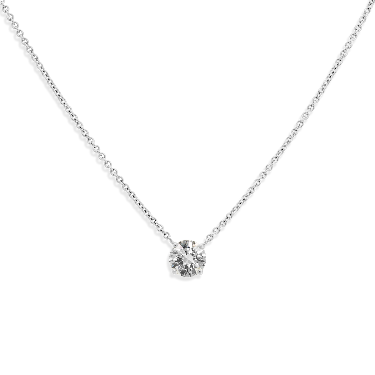 The ultimate timeless piece. A solitaire round brilliant is centered between the collarbone on an 18k gold chain. Shown here in White Gold.