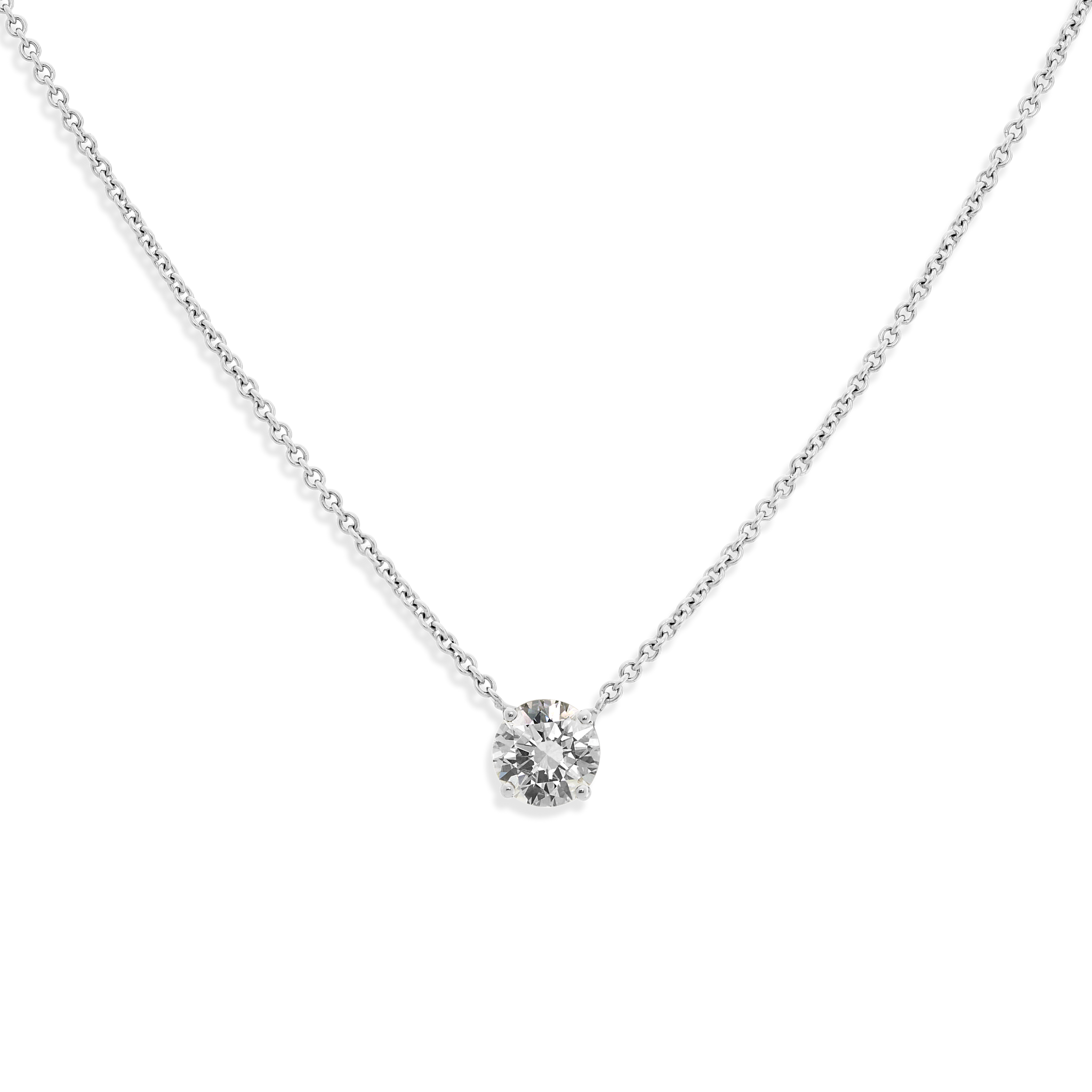 The ultimate timeless piece. A solitaire round brilliant is centered between the collarbone on an 18k gold chain. Shown here in White Gold.
