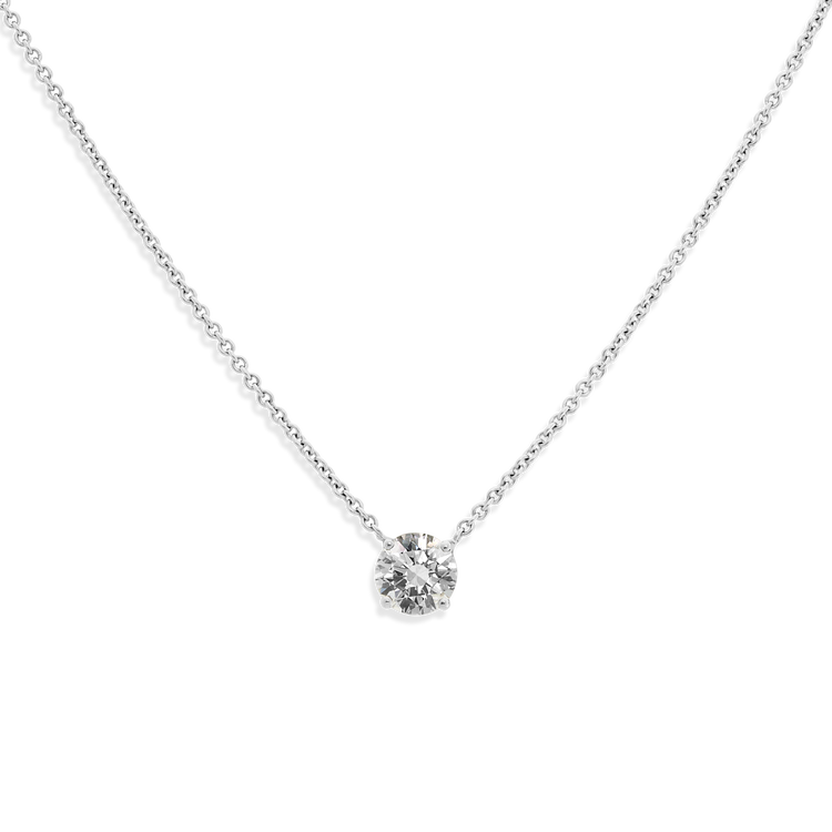The ultimate timeless piece. A solitaire round brilliant is centered between the collarbone on an 18k gold chain. Shown here in White Gold.
