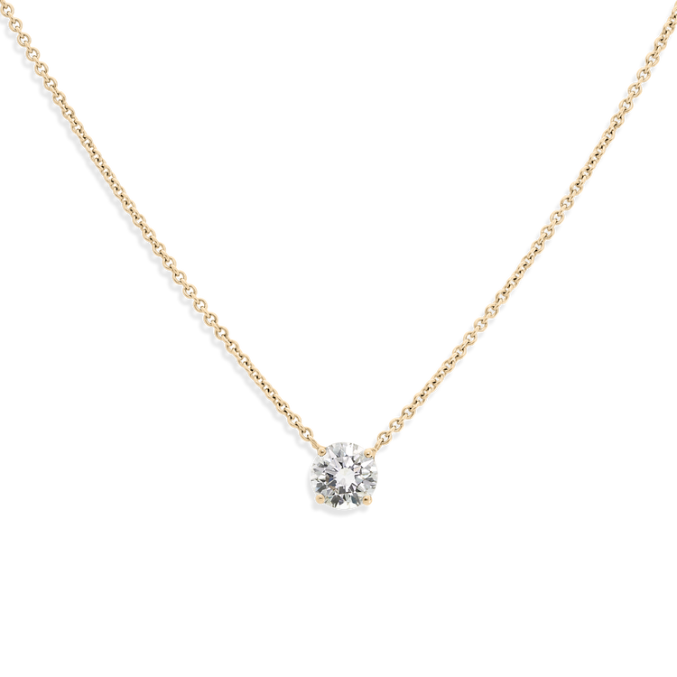 The ultimate timeless piece. A solitaire round brilliant is centered between the collarbone on an 18k gold chain. Shown here in Yellow Gold.