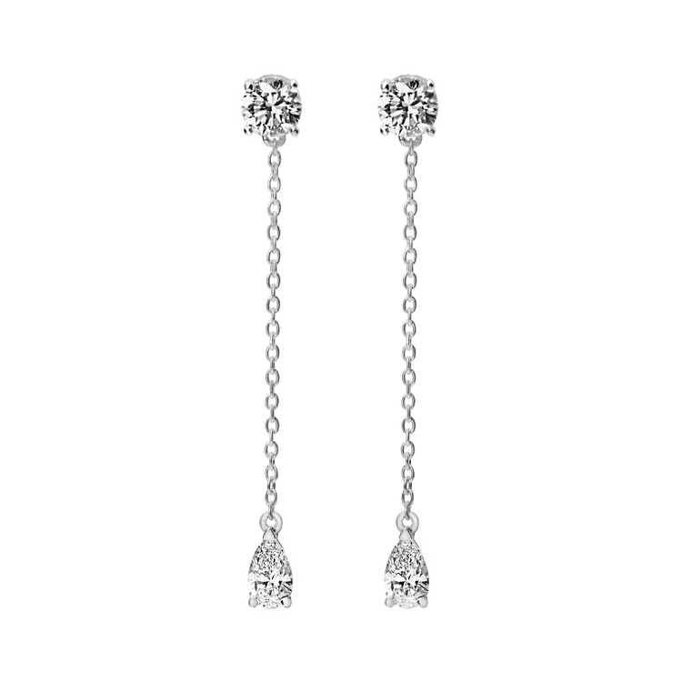 Full of movement, these hanging diamond earrings are strung with a round and pear diamond totaling 0.8 carat and separated by 1 inch of recycled 18k gold. Pair with other pieces in the Lariat collection, Lariat Trois, and the Lariat Necklace. Shown in White Gold here. Sold as a pair.