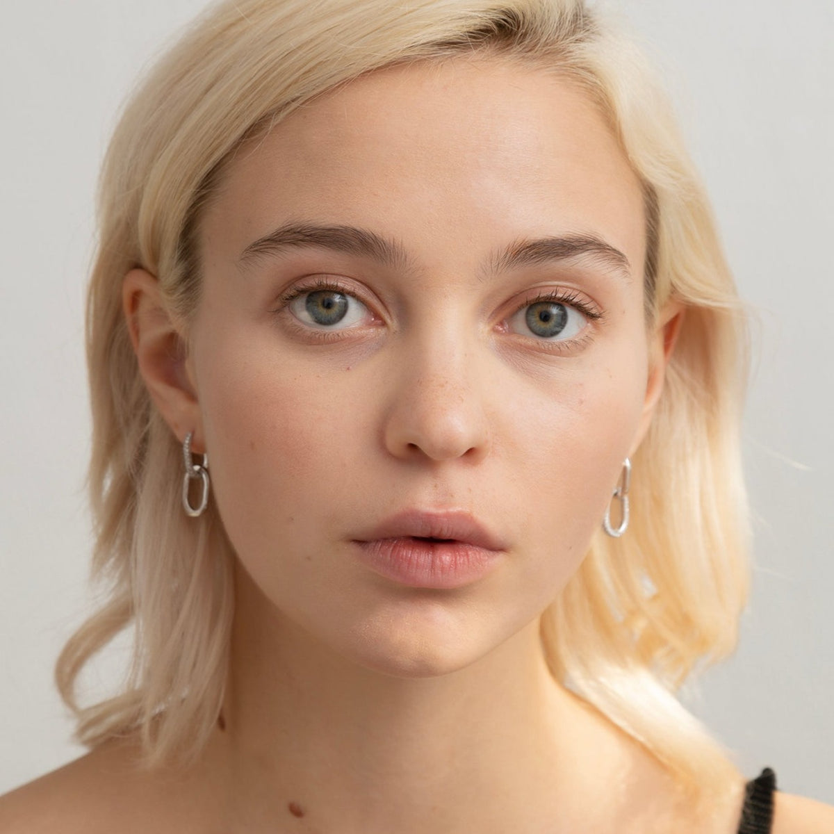 Floating Ecluse double link earrings have complementary diamond / gold links. The left earring has diamonds on the first hoop and gold on the second link - whereas the other earring has the opposite (gold on the top hoop and a diamond hoop attached below). White Gold shown here.
