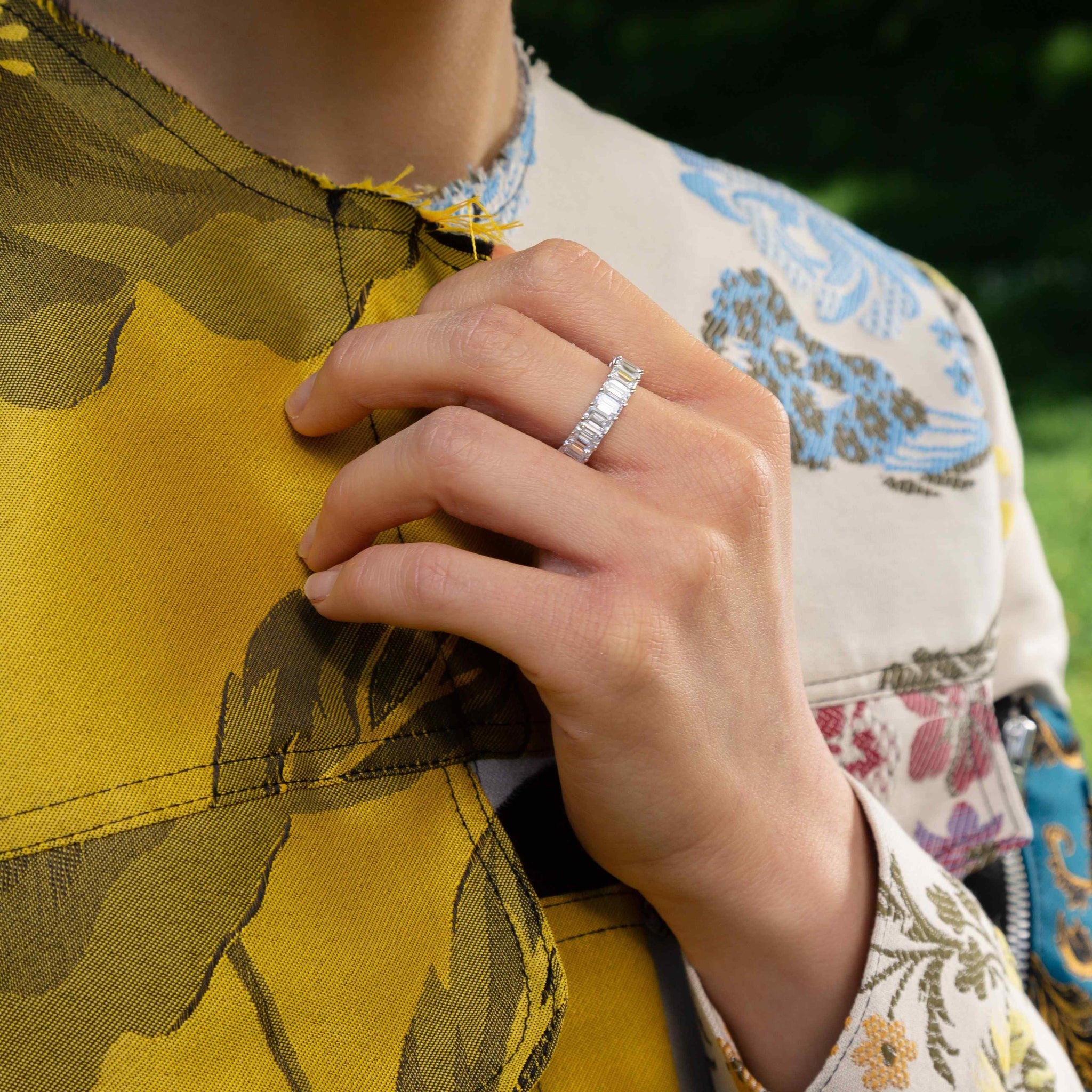 The Sans Cesse Emerald Eternity Ring - shown here in 18K White Gold and Palladium - is made of lab-grown D color, IF/VVS clarity diamonds and recycled 18K gold.