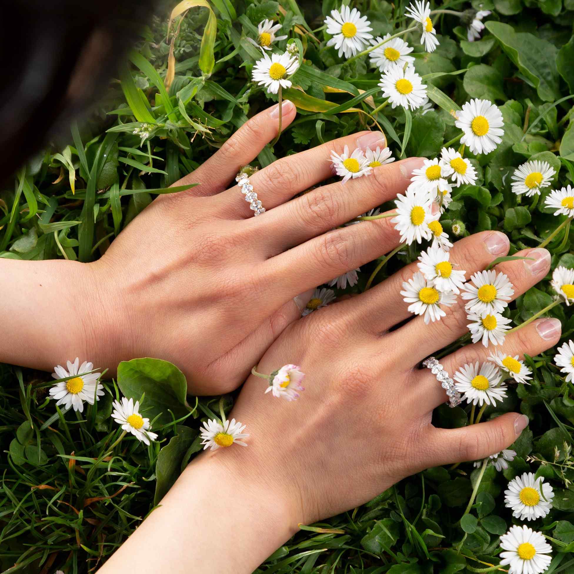 The Sans Cesse Oval Eternity - shown here in both 18K Yellow and White Gold on the model's hands - are made with D color, IF/VVS clarity diamonds. The 5 total carat weight sizes are shown here.