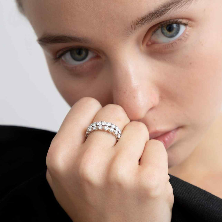 The Solene Eternity Ring - paired with the Sans Cesse Round Eternity - features D color, IF/VVS clarity round brilliant diamonds. The diamonds are held in an elegantly-spaced single-prong 18k gold eternity band. Size and color are fully customizable. Total carat weight of 2 (based on a U.S. size 7).
